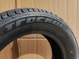 a close up of a tire on a cardboard box with a cardboard box in the background