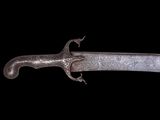 a close up of a knife on a black background with a black background
