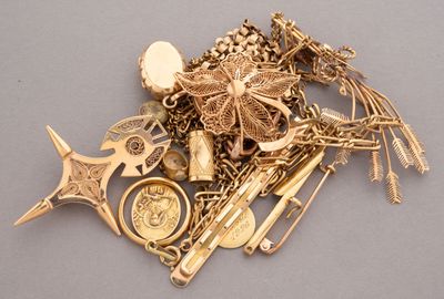 a pile of gold jewelry sitting on a table