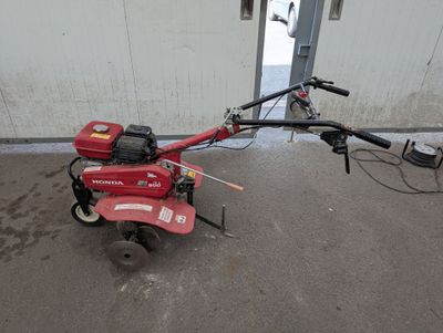 an image of a small tiller in a garage