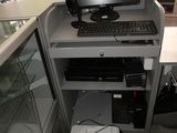 a computer desk with a printer and a monitor on it