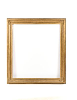 a gold picture frame on a white wall with a white background