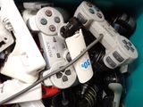 many video game controllers sitting in a blue container