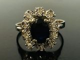 a close up of a ring with a blue stone in it