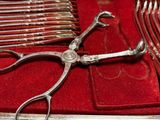 a pair of scissors sitting on top of a red case