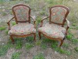 une paire de chaises rembourrées anciennes au milieu d'un champ d'herbe