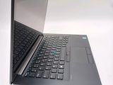 a black laptop with a blue keyboard on a white surface