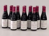 six bottles of wine are lined up in a row on a table