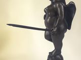 statue of a cupid holding a sword on a black base