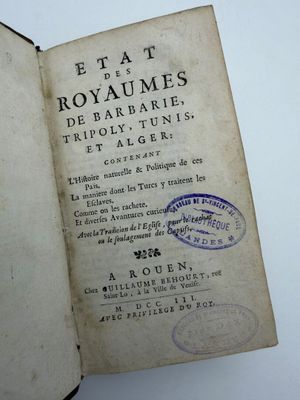 an open book with a stamp on it sitting on a table