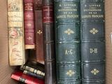 many books in a box that are sitting on a table