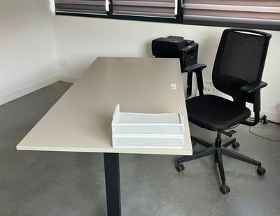 a desk with a chair and a printer on it