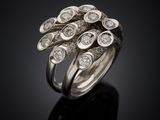a close up of a diamond ring on a black surface