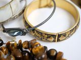 two bracelets and a bangle sitting on a table