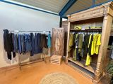 a room with a lot of clothes hanging on a rack