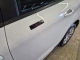 a white car with a sticker on the side of it
