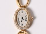 an image of a gold watch with a diamond bezeled face