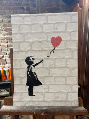 painting of a girl with a red balloon on a brick wall