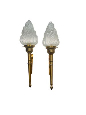 pair of brass and frosted glass sconces on a white background