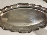 a silver tray sitting on a table with a white table cloth