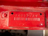 a close up of a number plate on a red car