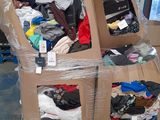 a cardboard box with clothes in it sitting on a pallet