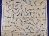 a blue and white scarf with fish on it