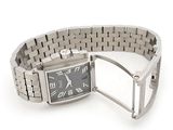 a watch that is sitting on a bracelet on a white surface