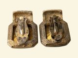 a pair of silver colored metal buckles on a white background