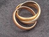 a gold ring that is laying on top of a cloth