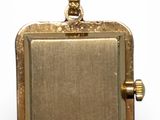 a close up of a gold locke with a chain on a white background