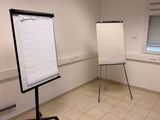 a white board in the middle of a room next to a window