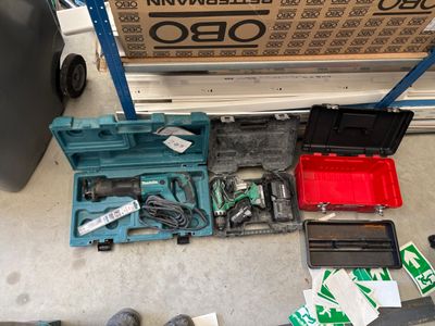 a box of tools sitting on the floor next to a pair of shoes