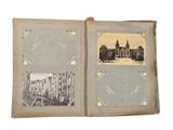 an old photo of a book with a picture of a city in it