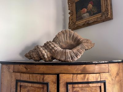 a picture of a wooden cabinet with a shell on top of it