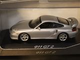 a silver toy car in a box on a table