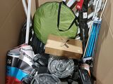 a cardboard box filled with assorted skis and ski poles