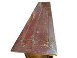 a wooden table with a red top on a white background