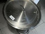 a large metal pan sitting on the floor in a kitchen