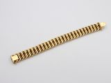 a gold bracelet with a curb link