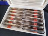 a lot of silverware in a case on a table