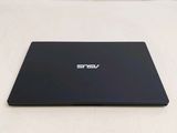 the back of a laptop computer sitting on top of a white surface