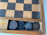 a wooden chess board with four pieces in it