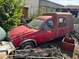a red van that is parked in the yard