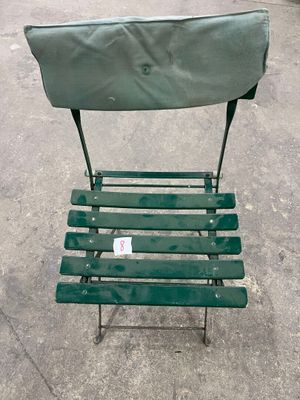 a green chair that is sitting in the street