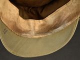 a brown hat with a brown visor on top of it