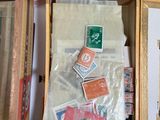 a wooden box filled with assorted stamps and other items