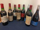 several bottles of wine are lined up on a table