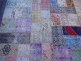 a patchwork rug with many different colors on it