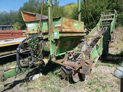 a large green machine that is sitting in the grass